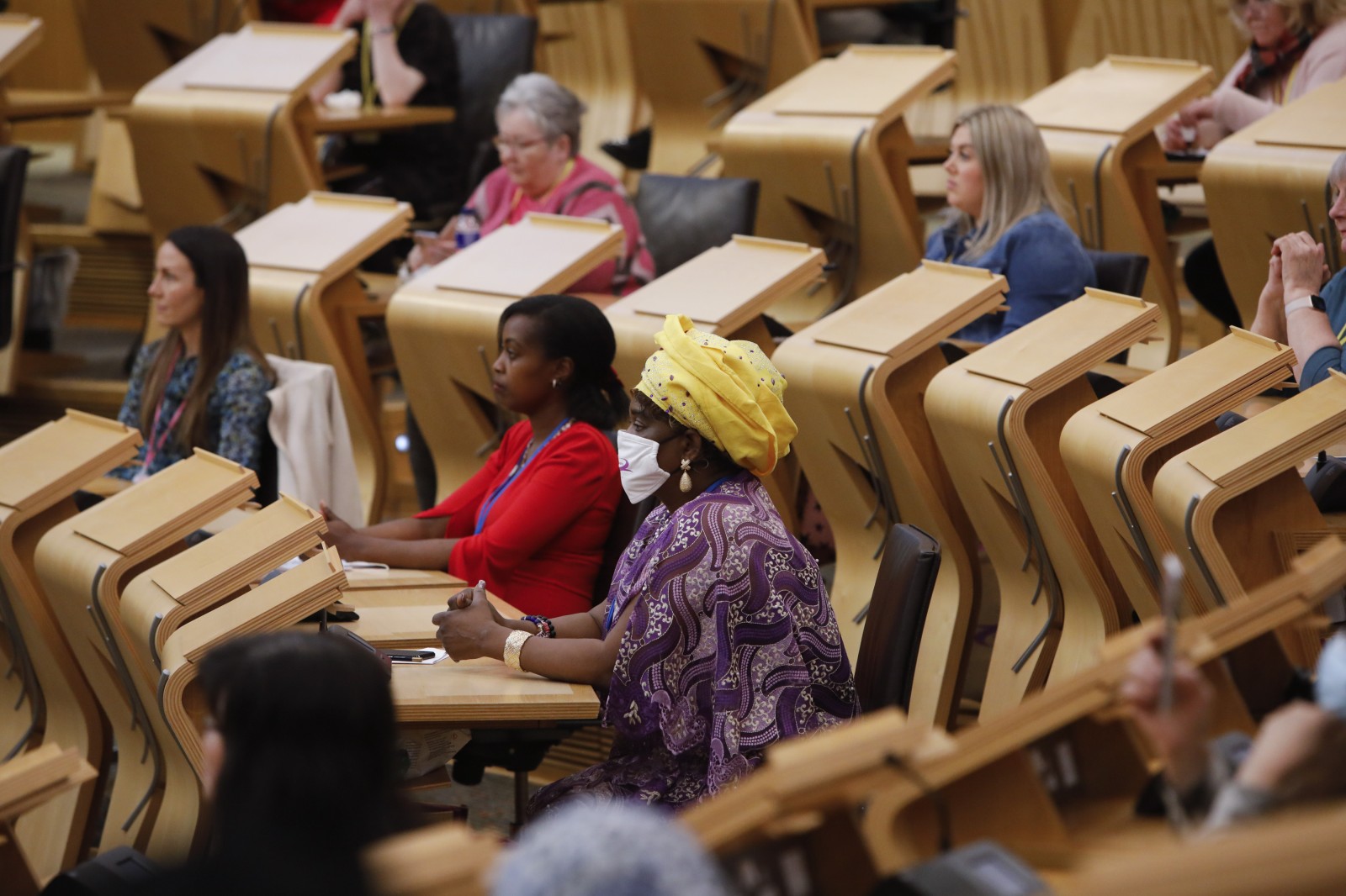 Participants look on during keynote speeches during the International Women's Day Conference held in the Debating Chamber of the Scottish Parliament. 05 March 2022.