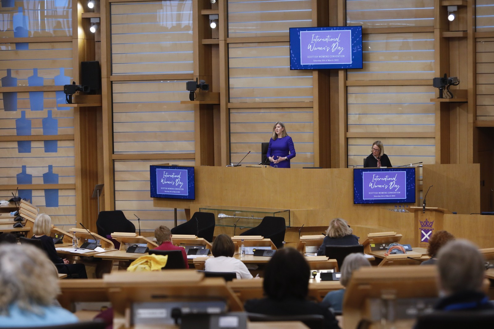 Participants look on during keynote speeches during the International Women's Day Conference held in the Debating Chamber of the Scottish Parliament. 05 March 2022.