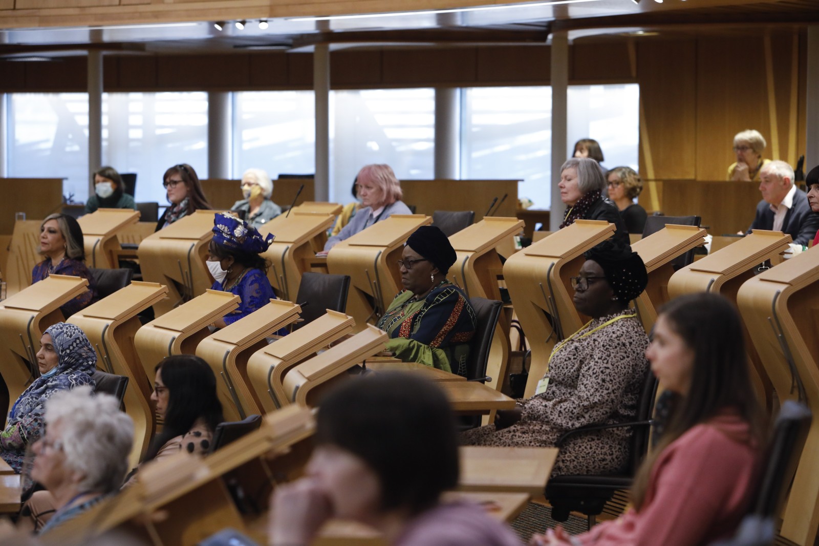 Participants look on during keynote speeches during the International Women's Day Conference held in the Debating Chamber of the Scottish Parliament. 05 March 2022.