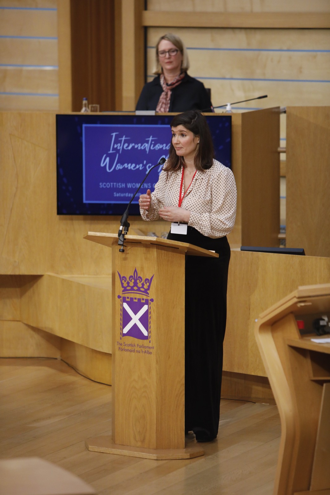 Actor Carmen Pieraccini making her keynote address during the International Women's Day Conference held in the Debating Chamber of the Scottish Parliament. 05 March 2022.