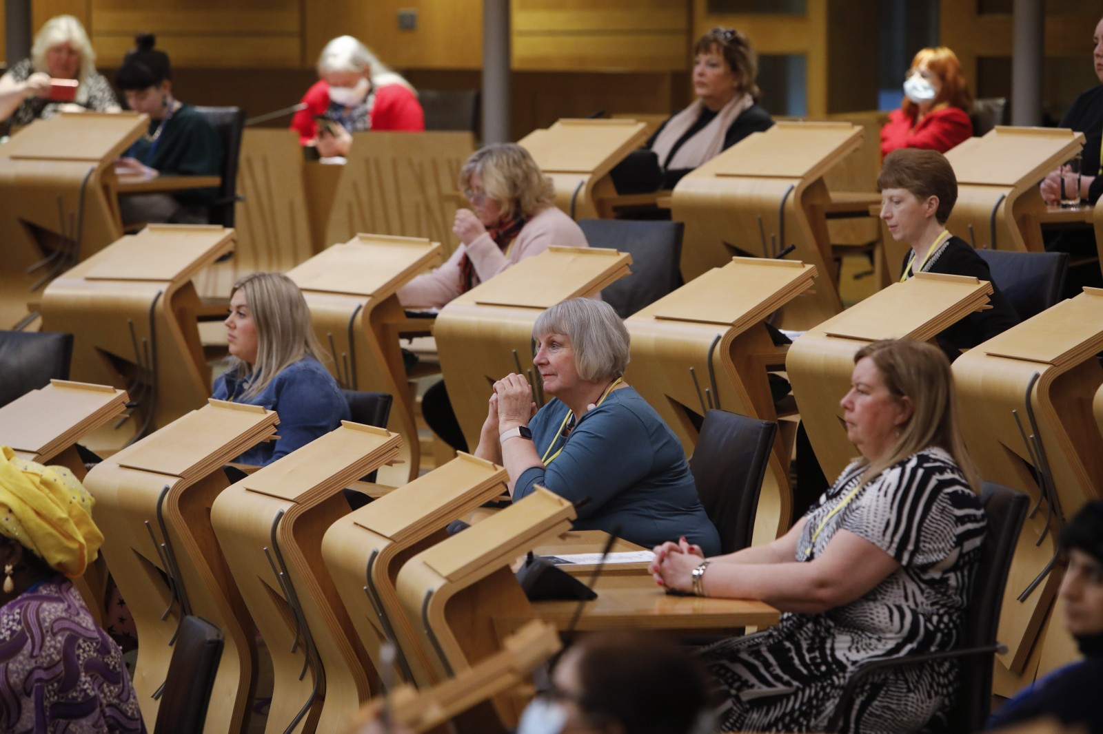 Participants look on during keynote speeches during the International Women's Day Conference held in the Debating Chamber of the Scottish Parliament. 05 March 2022.