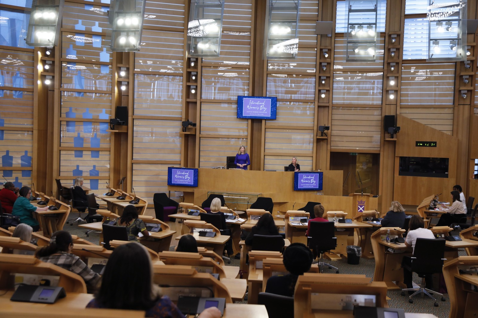 Participants look on during keynote speeches during the International Women's Day Conference held in the Debating Chamber of the Scottish Parliament. 05 March 2022.